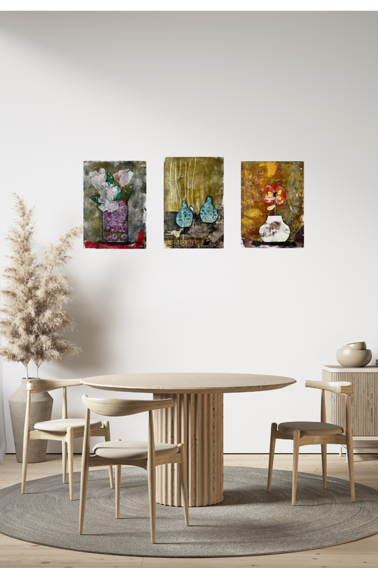 Dining room with a round wooden table and chairs, featuring three abstract paintings on the wall.