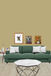 Green sofa with white cushions in a living room setting with framed pictures on the wall.