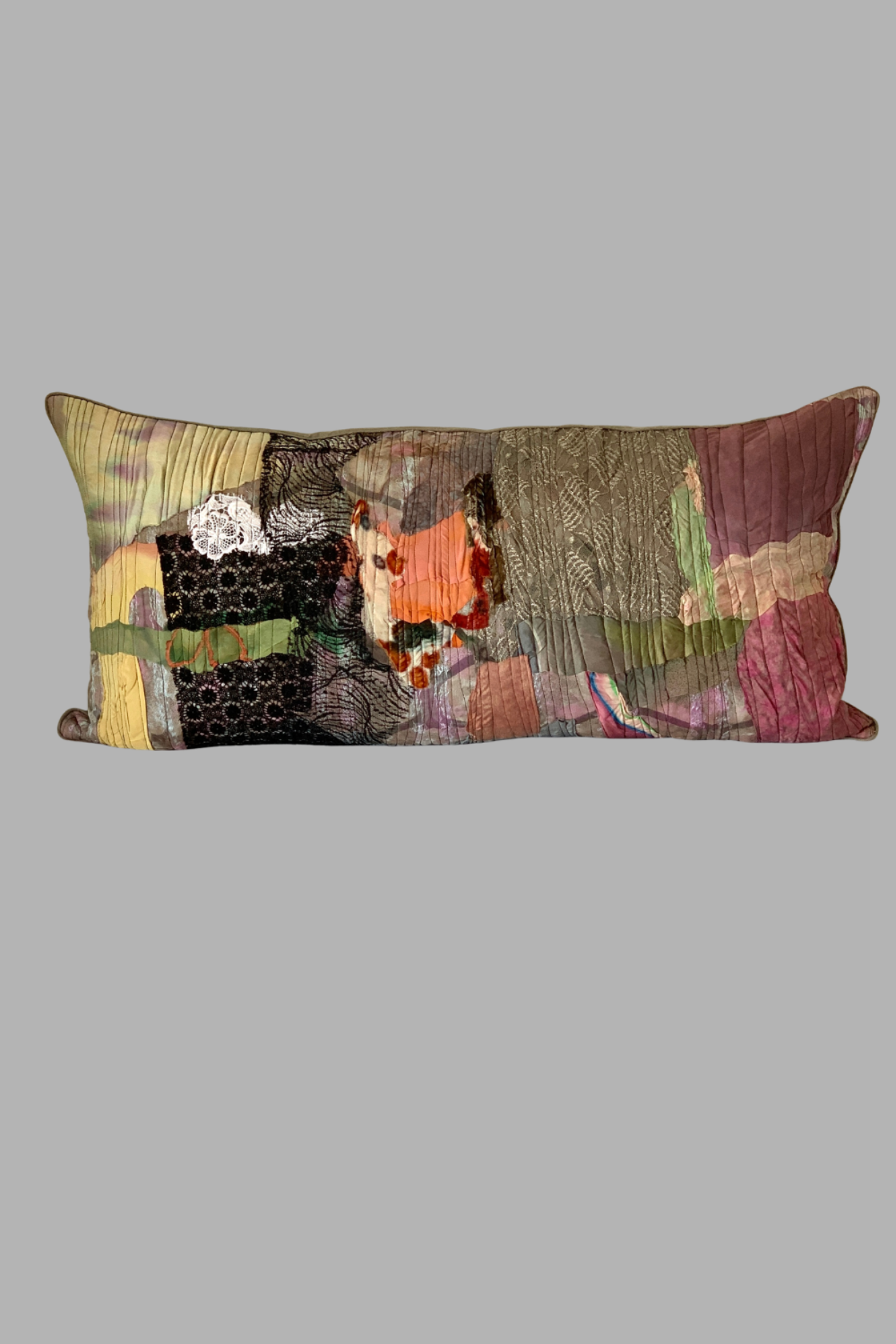 Multicolored patchwork pillow on a gray background