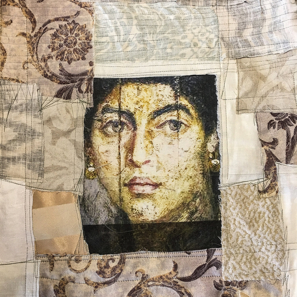 Textile art portrait of a woman’s face printed on fabric and stitched into a patchwork of vintage-inspired textiles in beige and gold tones.