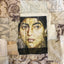 Textile art portrait of a woman’s face printed on fabric and stitched into a patchwork of vintage-inspired textiles in beige and gold tones.