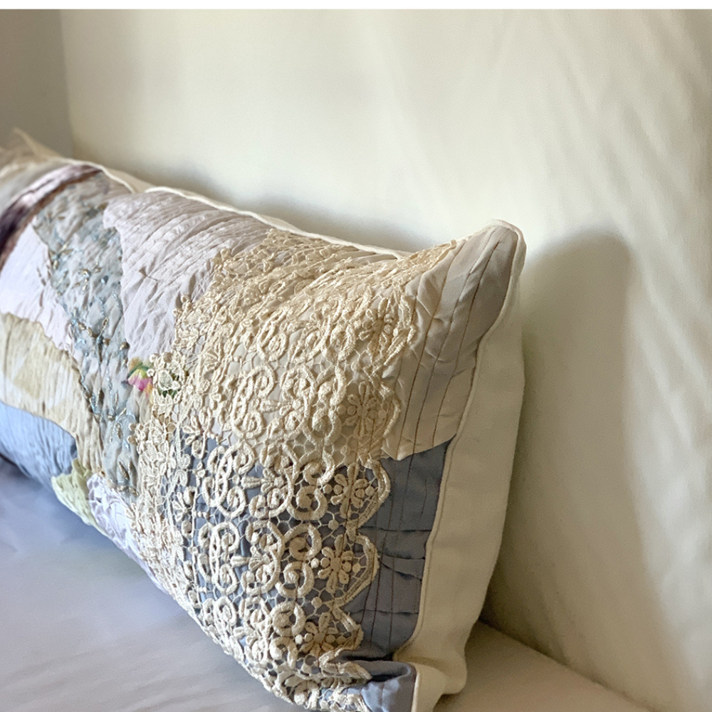 Decorative pillow with lace trim on a bed