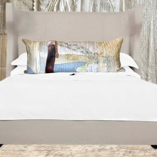 Decorative pillow on a bed with a textured wall in the background