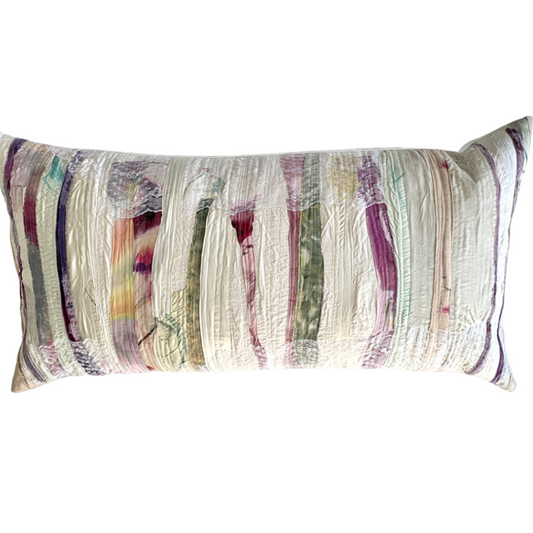 Multicolored striped pillow on a white background