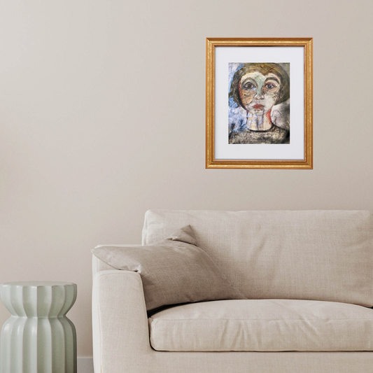 Colorful Portraits Fine Art Prints. Framed artwork of a face on a wall above a beige sofa.