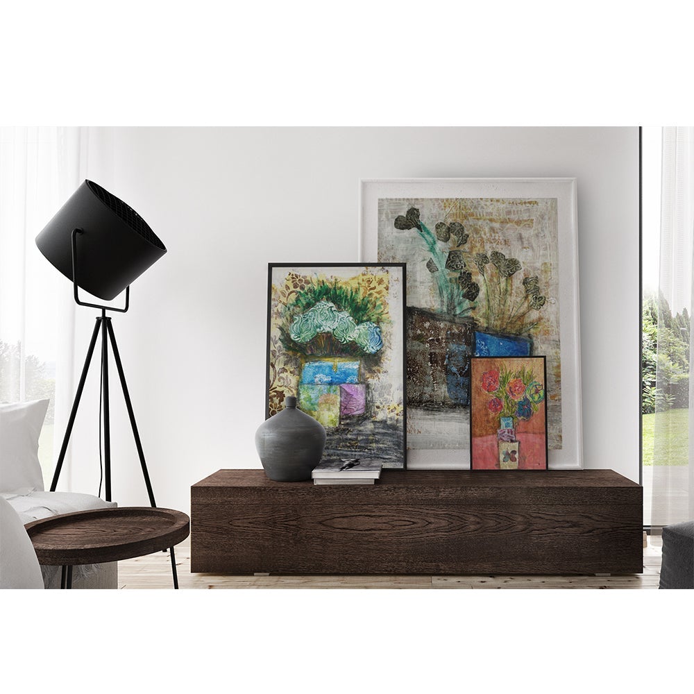 Mixed media collage titled Moon Tear by Sara Palacios. The artwork showcases dark leafy stems emerging from a two-toned vase—textured brown on one side, vibrant blue on the other—set against a softly layered cream and gold background with subtle patterns.