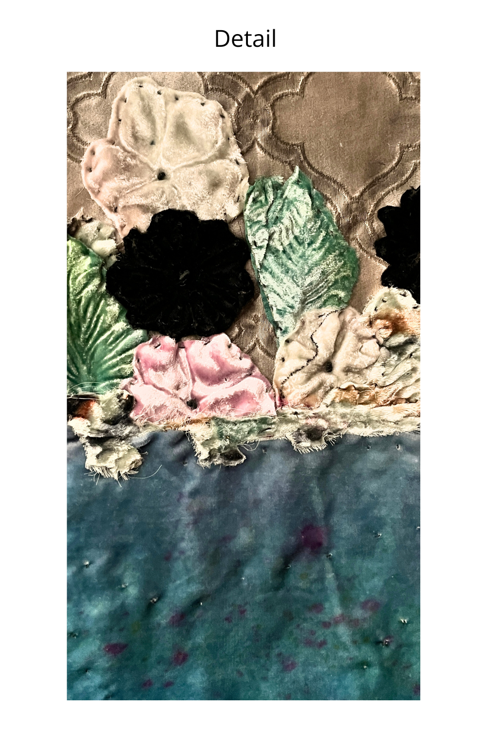 A close-up detail shot of a textured fabric artwork featuring layered floral and leaf motifs in black, pink, green, beige, and teal blue.
