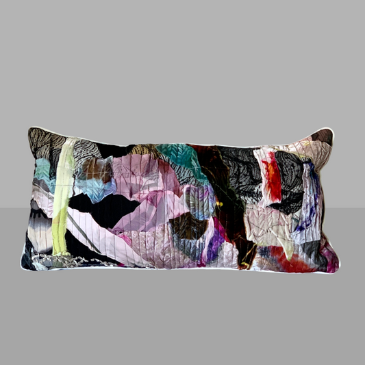 Colorful abstract-patterned pillow on a gray background