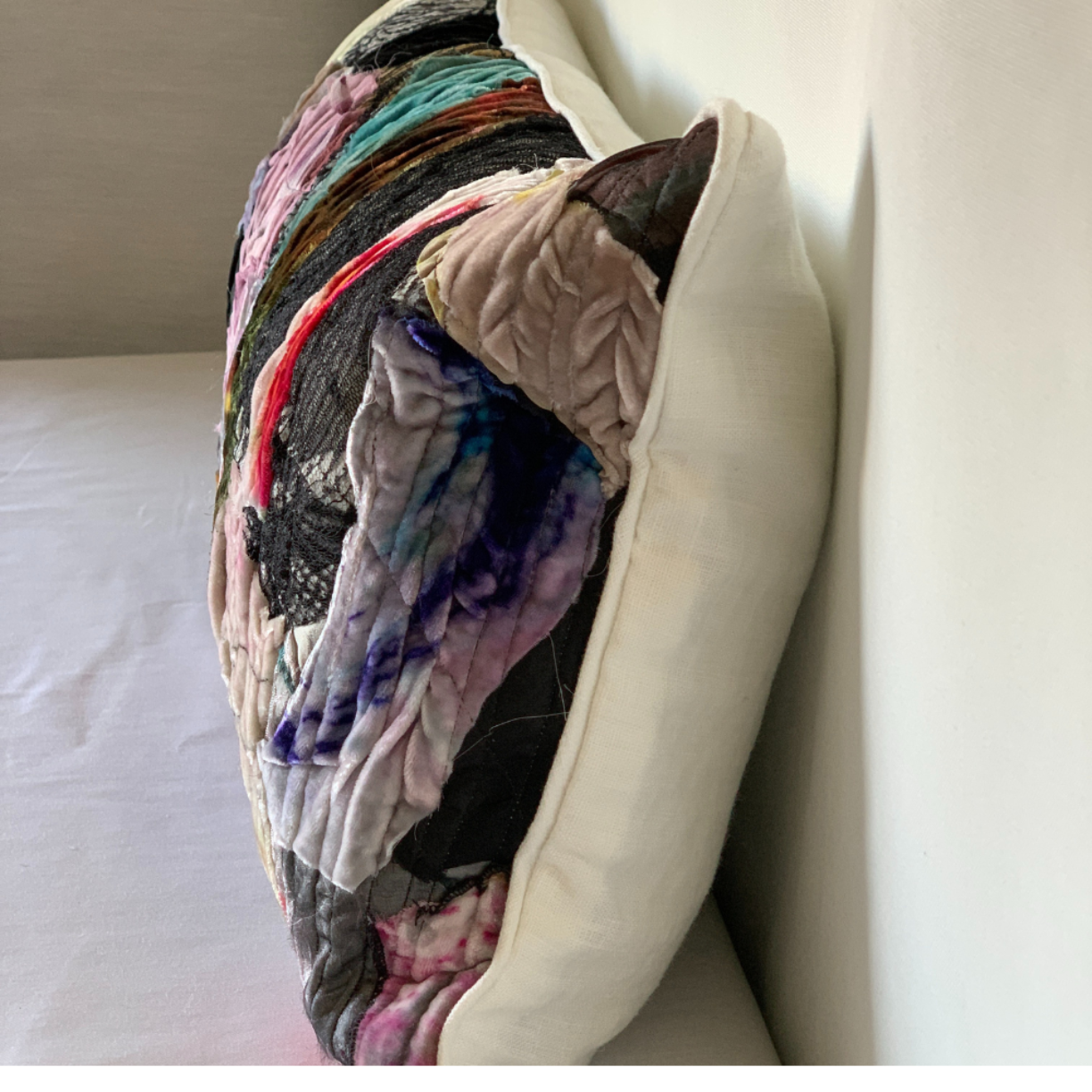 Multicolored textured pillow on a neutral background