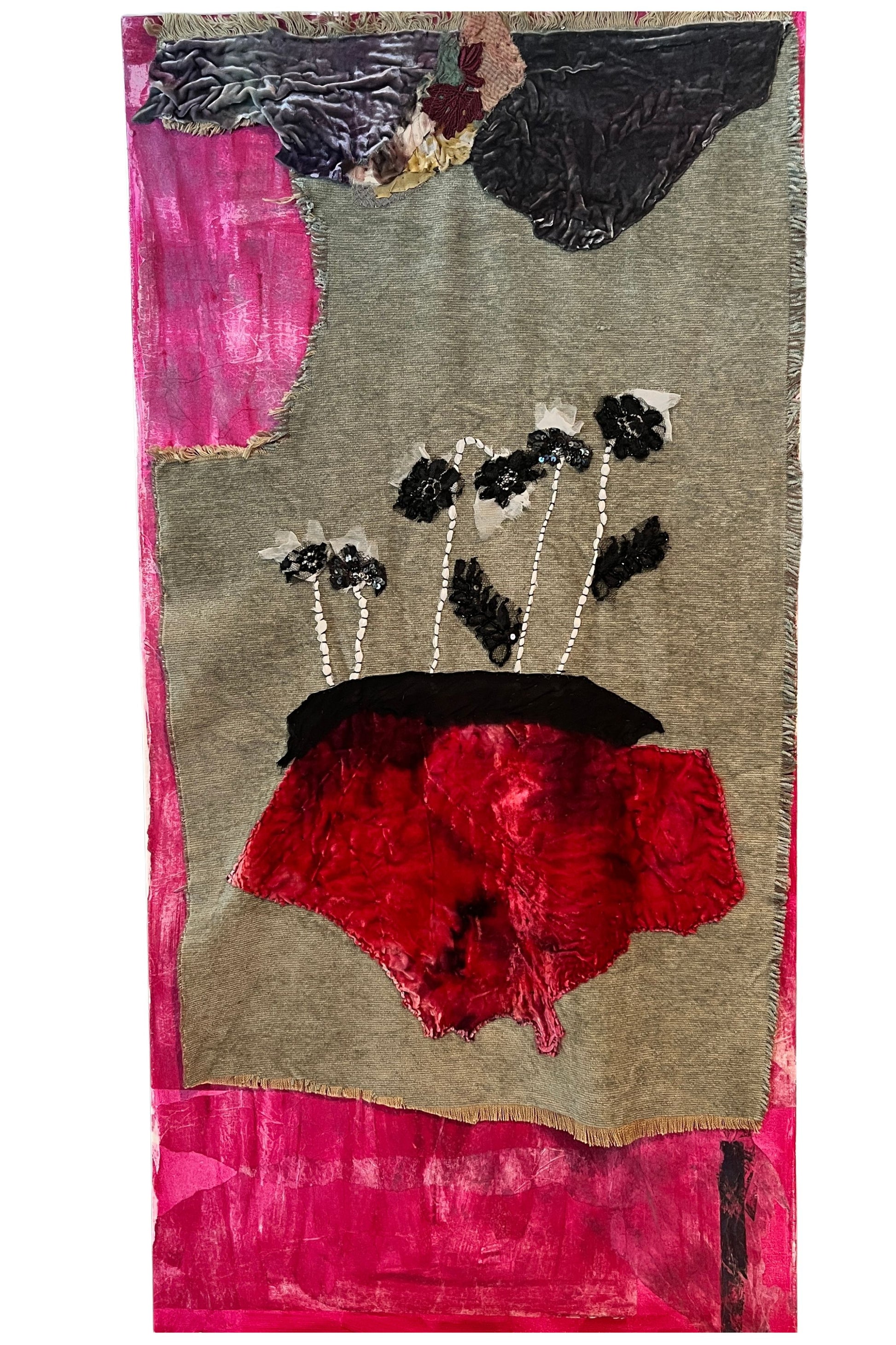 Textile art piece with floral patterns on a pink and gray background