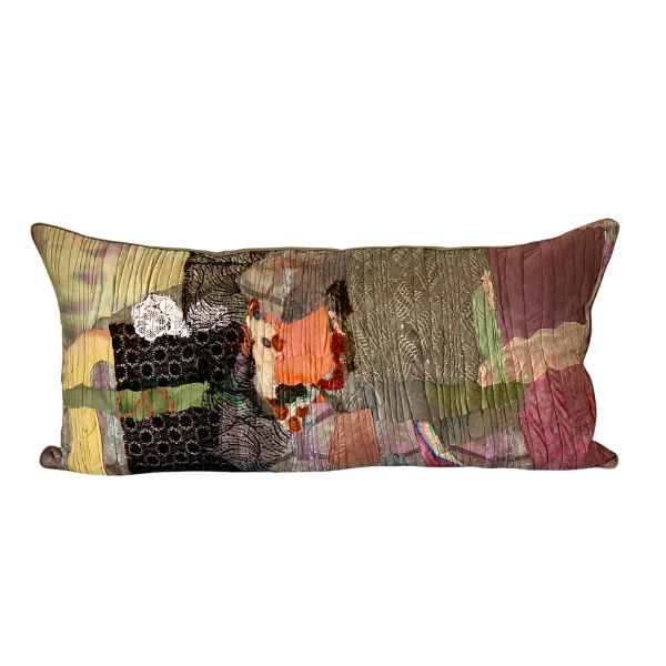 Decorative pillow with a patchwork design on a white background