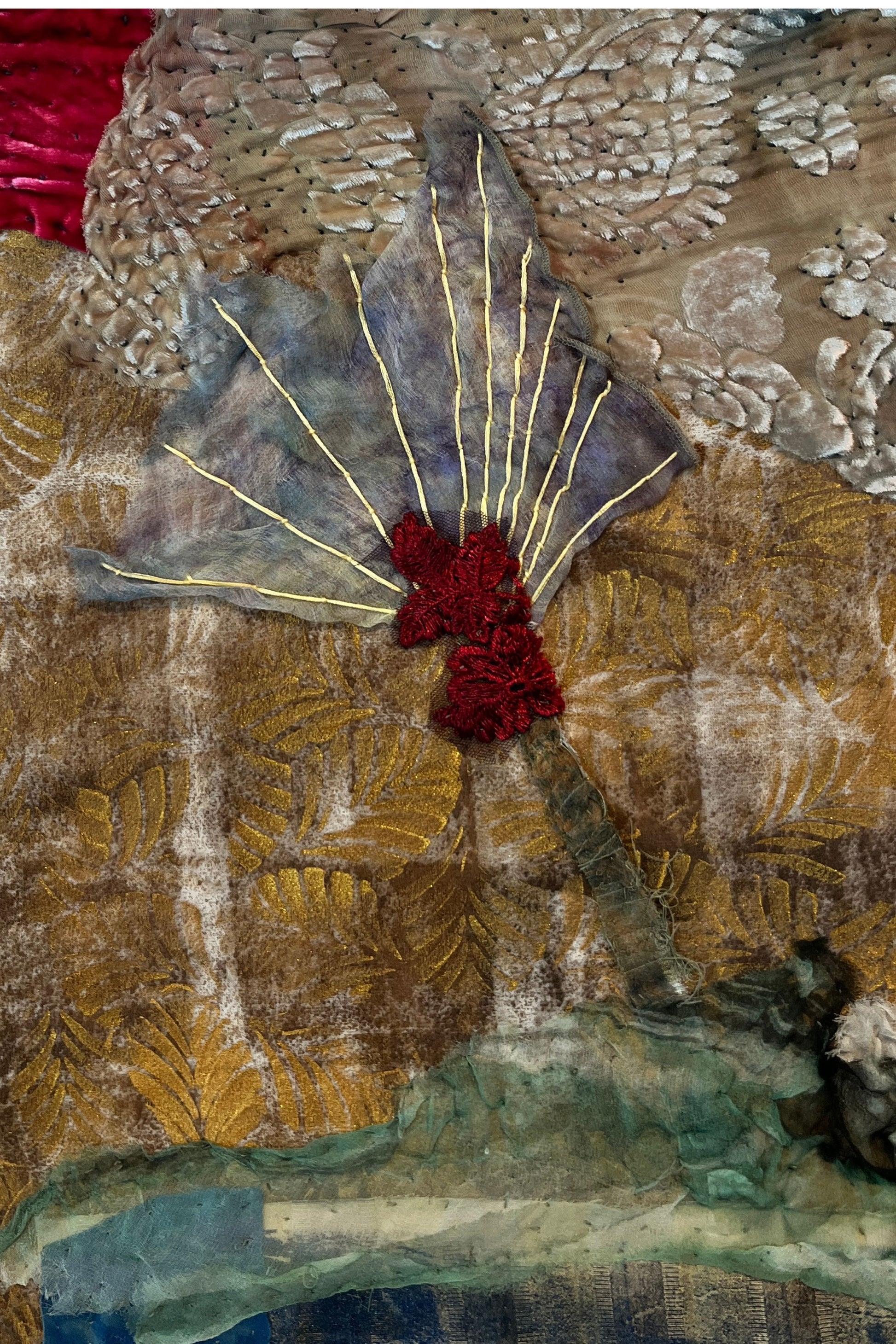 Textile art piece with floral design and textured background
