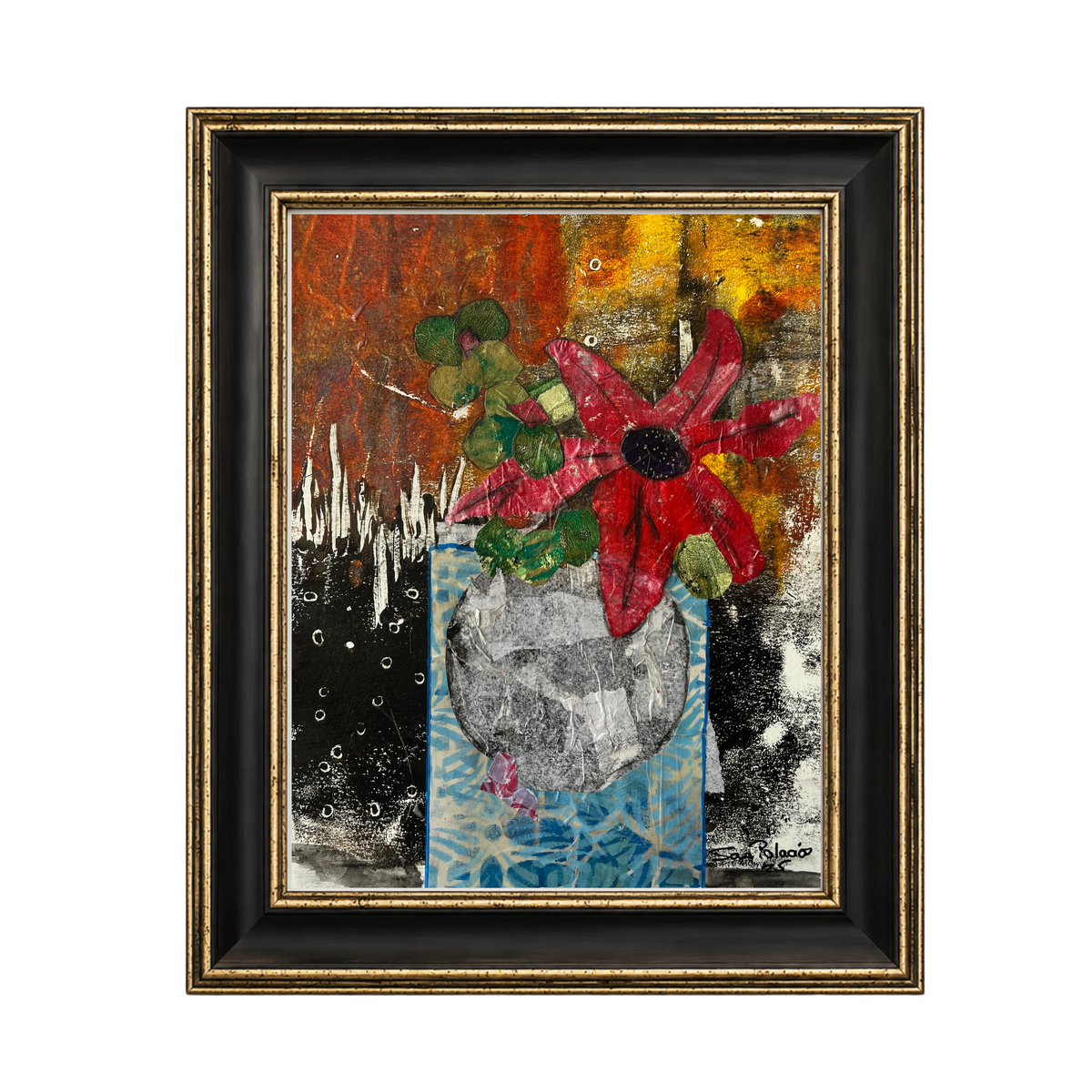 A framed abstract mixed-media painting featuring a red flower with green leaves in a blue patterned vase, set against a textured background of orange, black, and yellow. The artwork is housed in a black frame with a gold inner border and outer gold trim, shown against a plain white background.