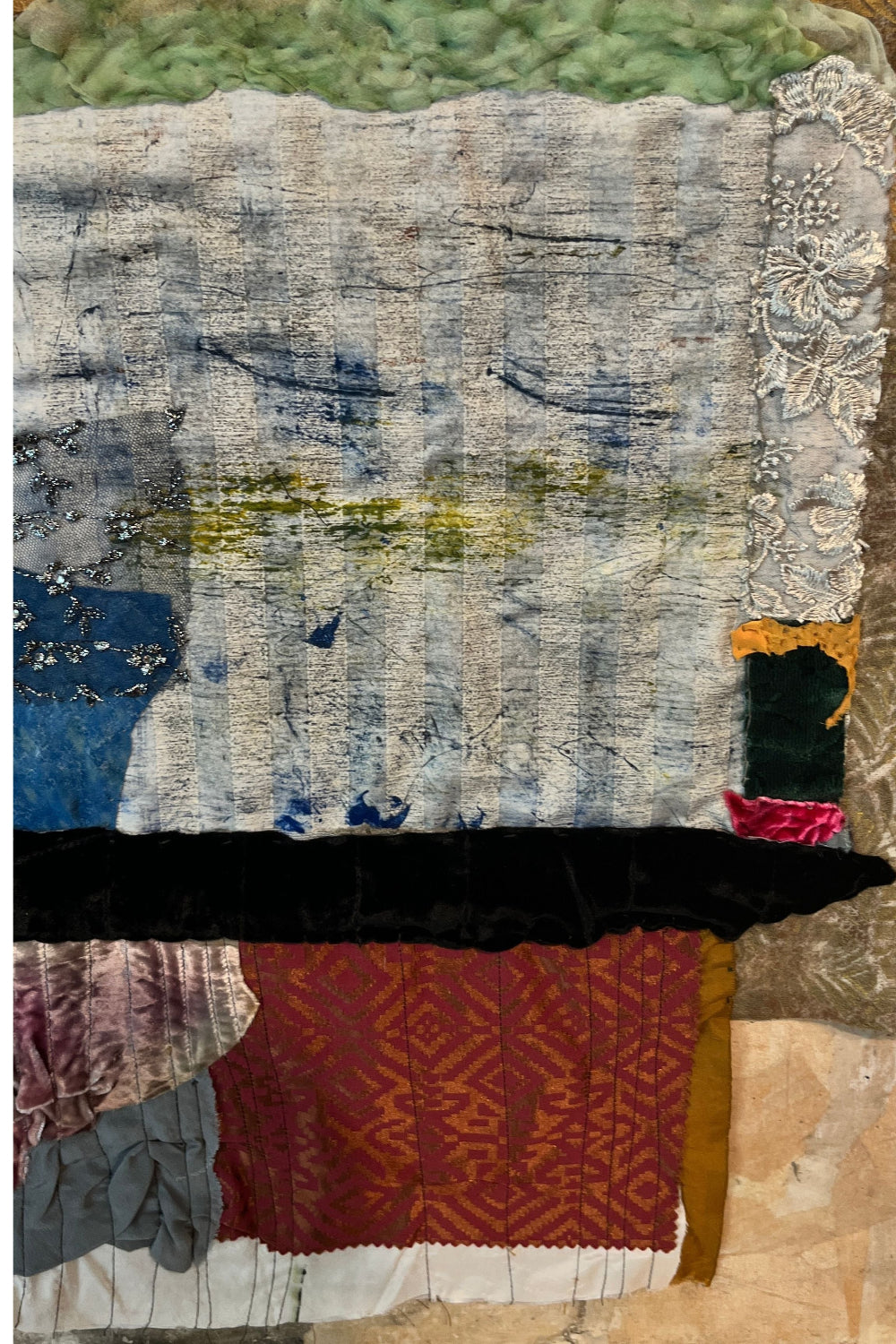 Textile art piece with various fabrics and patterns