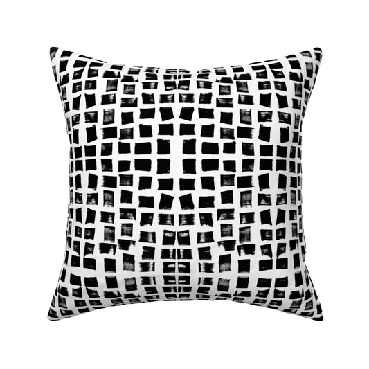 Black and white checkered pillow on a white background