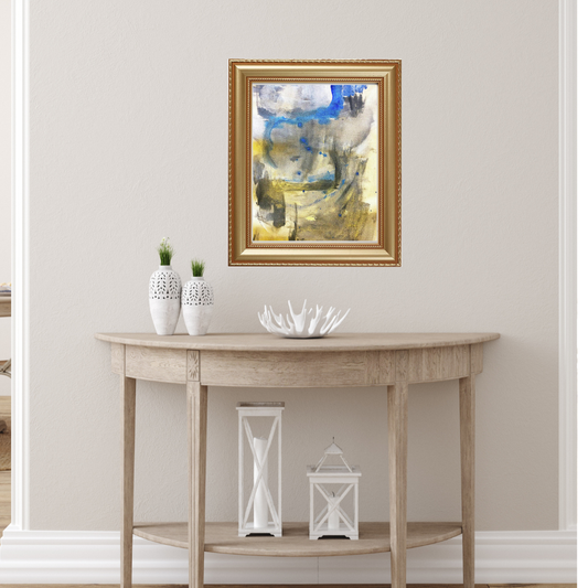 Abstract artwork framed in a gold framed on top of a side table