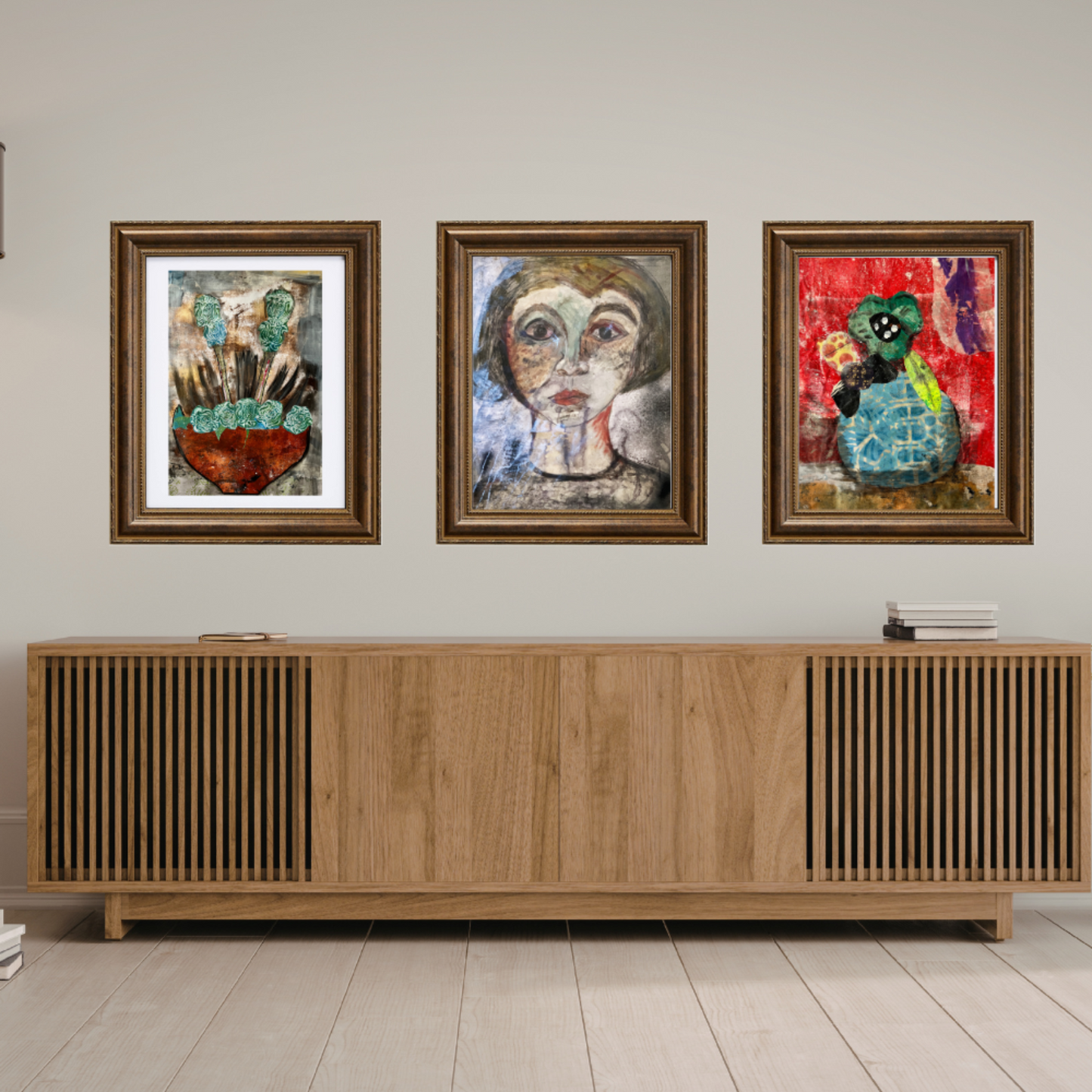 Wall art. Three framed artworks on a wall above a wooden sideboard.