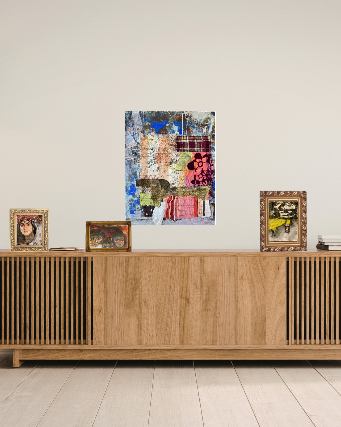Wooden sideboard with framed pictures against a white wall