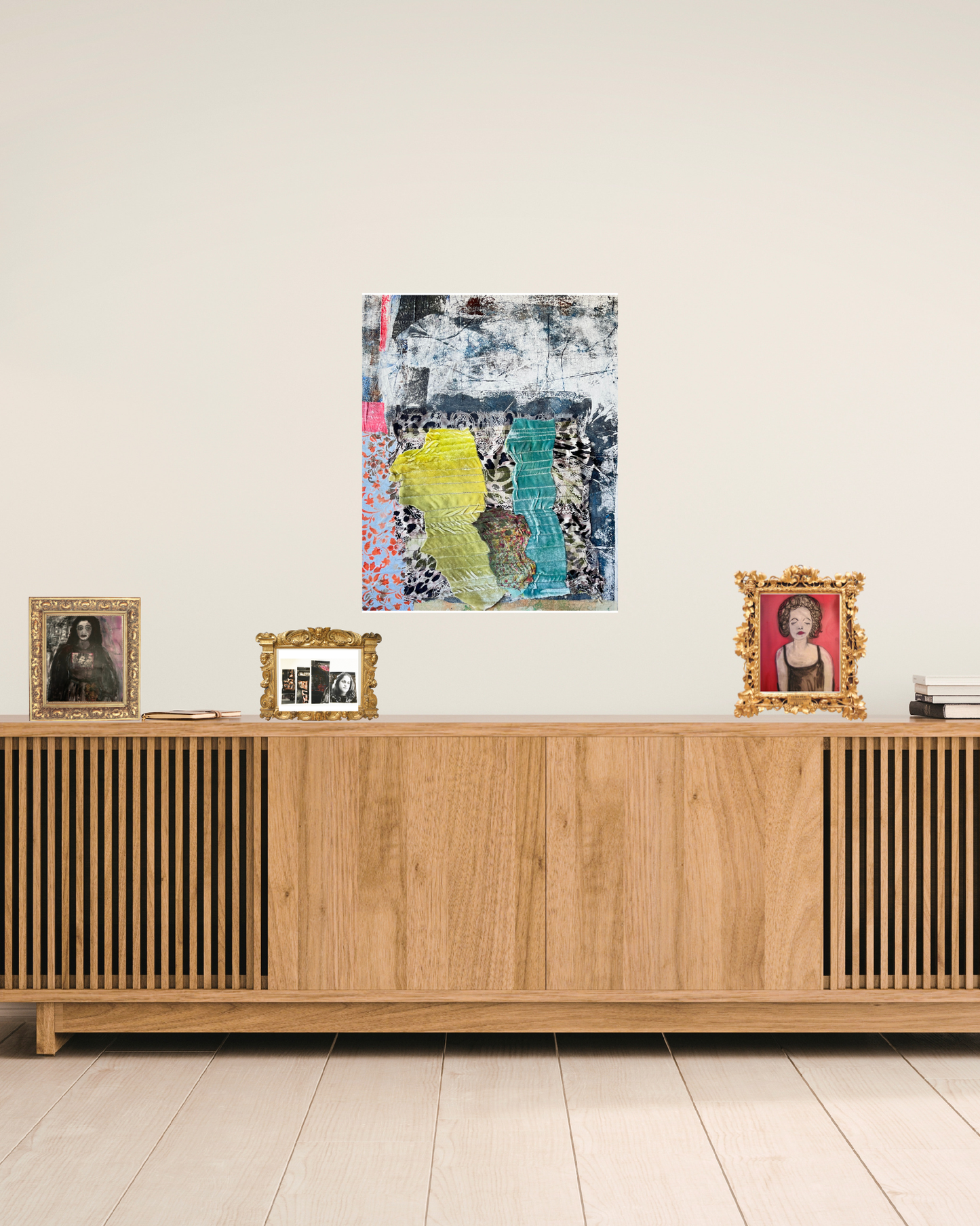 Wooden sideboard with decorative items and framed pictures in a room.