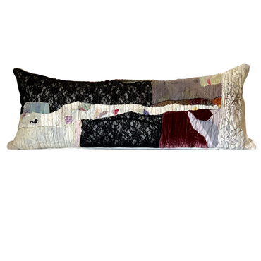 Long rectangular pillow with patchwork design on a white background