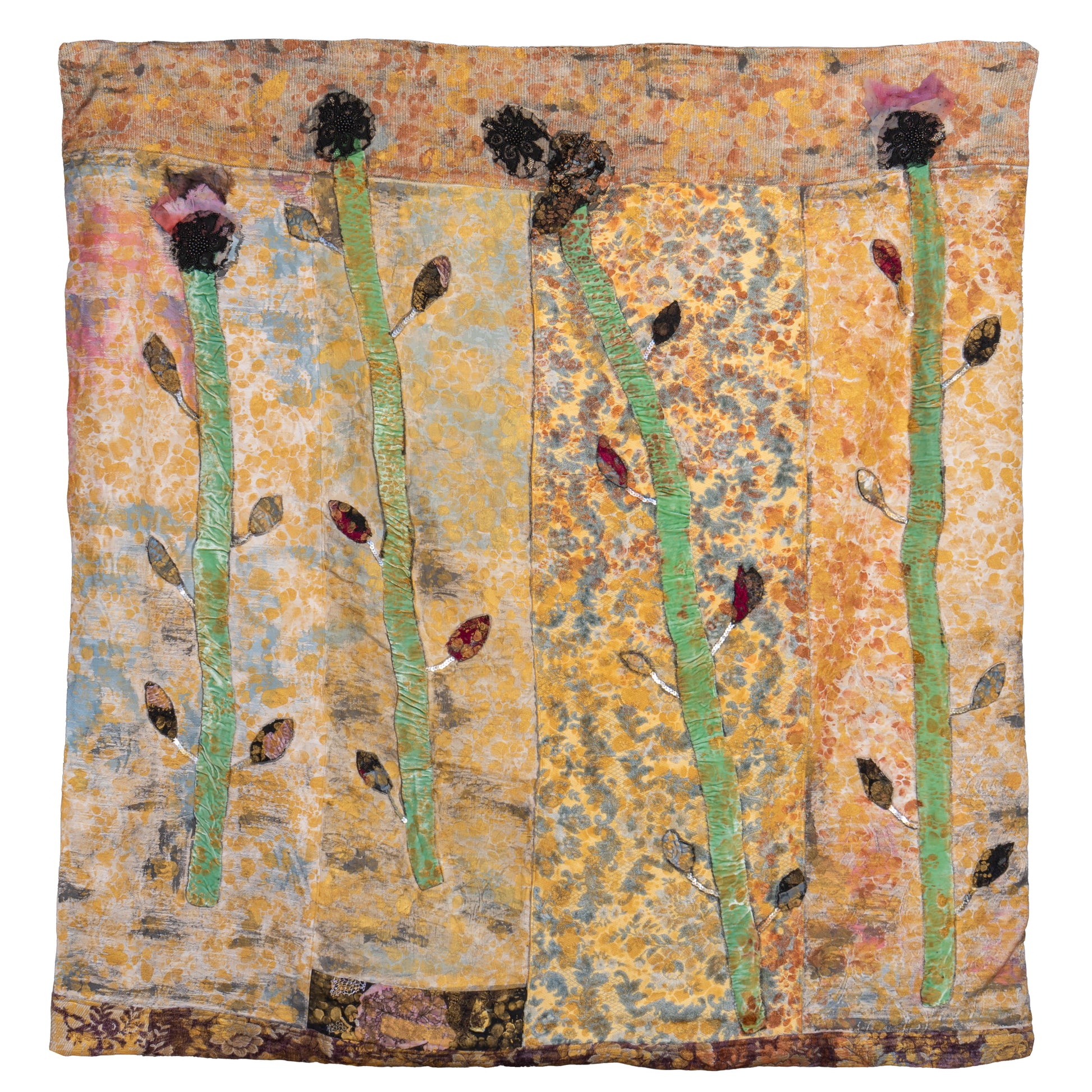 A square textile art piece featuring four tall green stems with dark seed heads and small brown and red leaves, set against a mottled background of gold, orange, and blue tones.