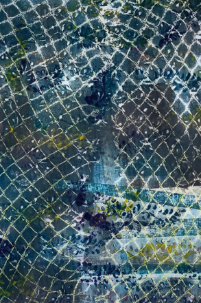 Close-up of a textured surface with geometric patterns in blue, green, and gray.