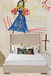 lumbar pillow on top of a bed with a drawing as a wall paper