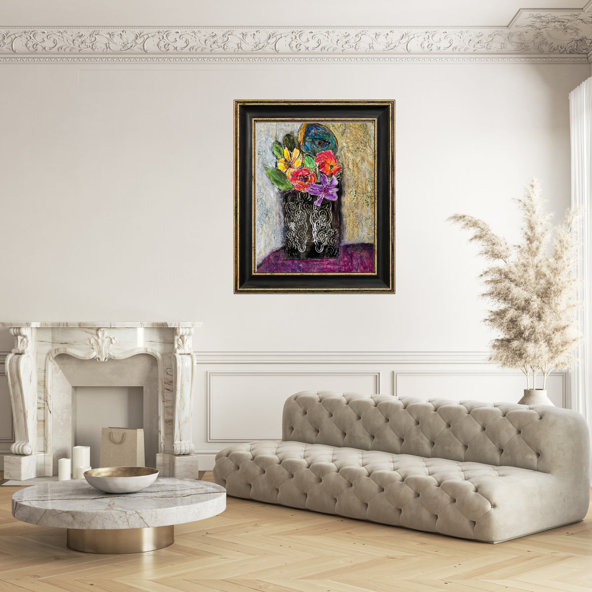 A framed painting of a colorful flower bouquet in a dark vase, displayed on a white wall above a tufted beige sofa in a styled living room with a marble fireplace and round coffee table.