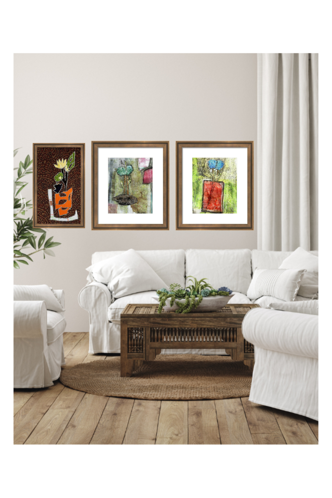 Living room with a white sofa, wooden coffee table, and framed artwork on the wall.