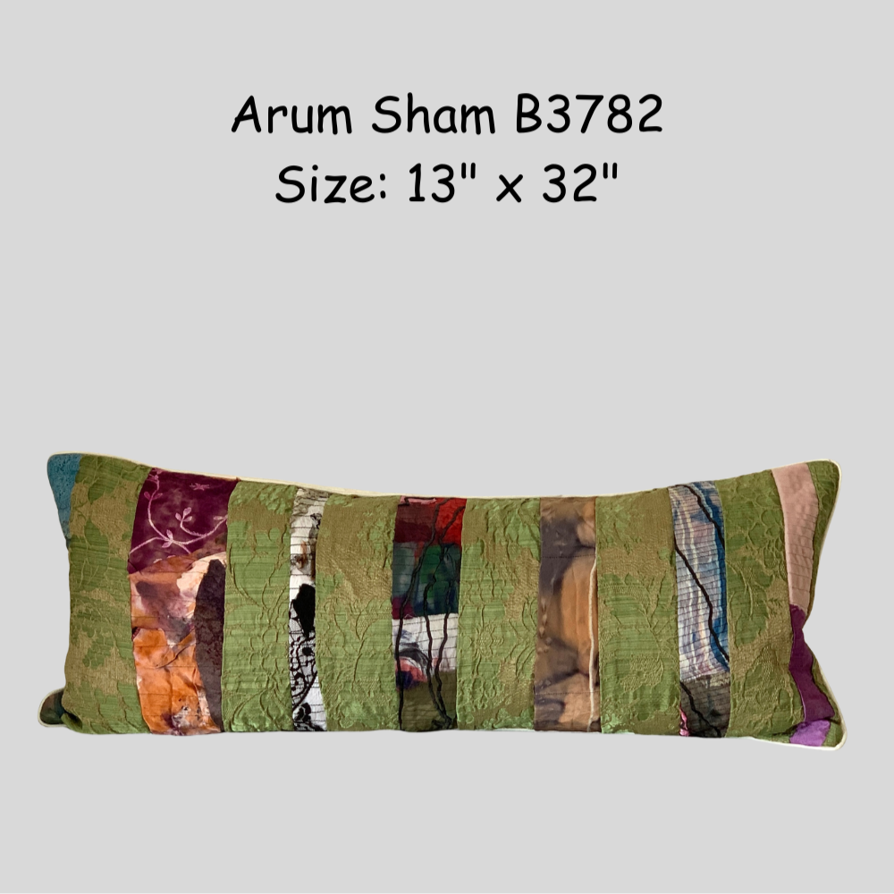 Colorful patchwork pillow with dimensions on a gray background