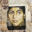 Textile art portrait of a woman’s face printed on fabric and stitched into a patchwork of vintage-inspired textiles in beige and gold tones.