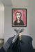 Expressionist portrait of a woman named Mirabel with intense eyes and dark clothing, set against red-pink abstract background. From the She in Red collection.