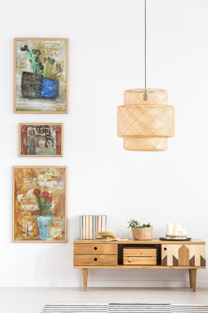 Mixed media collage titled Moon Tear by Sara Palacios. The artwork showcases dark leafy stems emerging from a two-toned vase—textured brown on one side, vibrant blue on the other—set against a softly layered cream and gold background with subtle patterns.