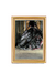 Framed artwork of a black dress with gold frame
