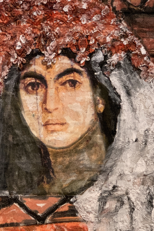 Close-up of a classical painting with a person wearing a headscarf.
