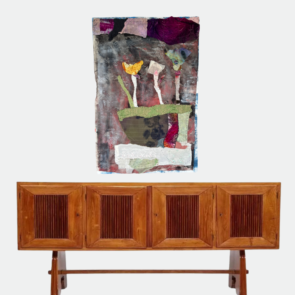 Wooden sideboard with abstract art above it on a white background