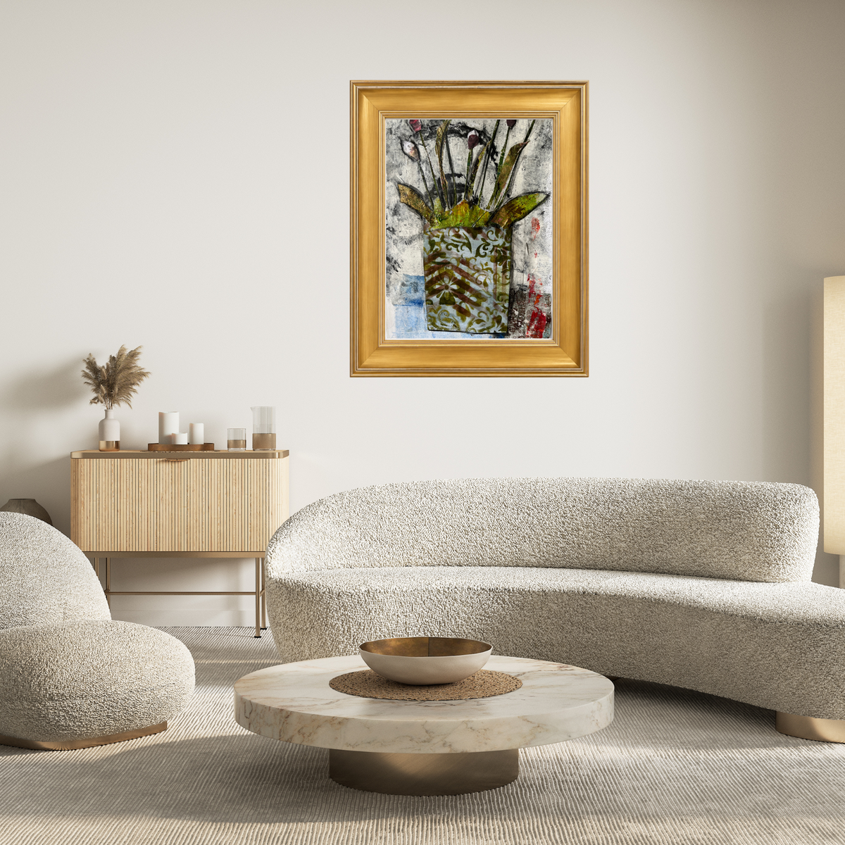 Framed mixed-media floral artwork featuring a patterned vase with stems and leaves, set within a frame gold shown in a modern living room.