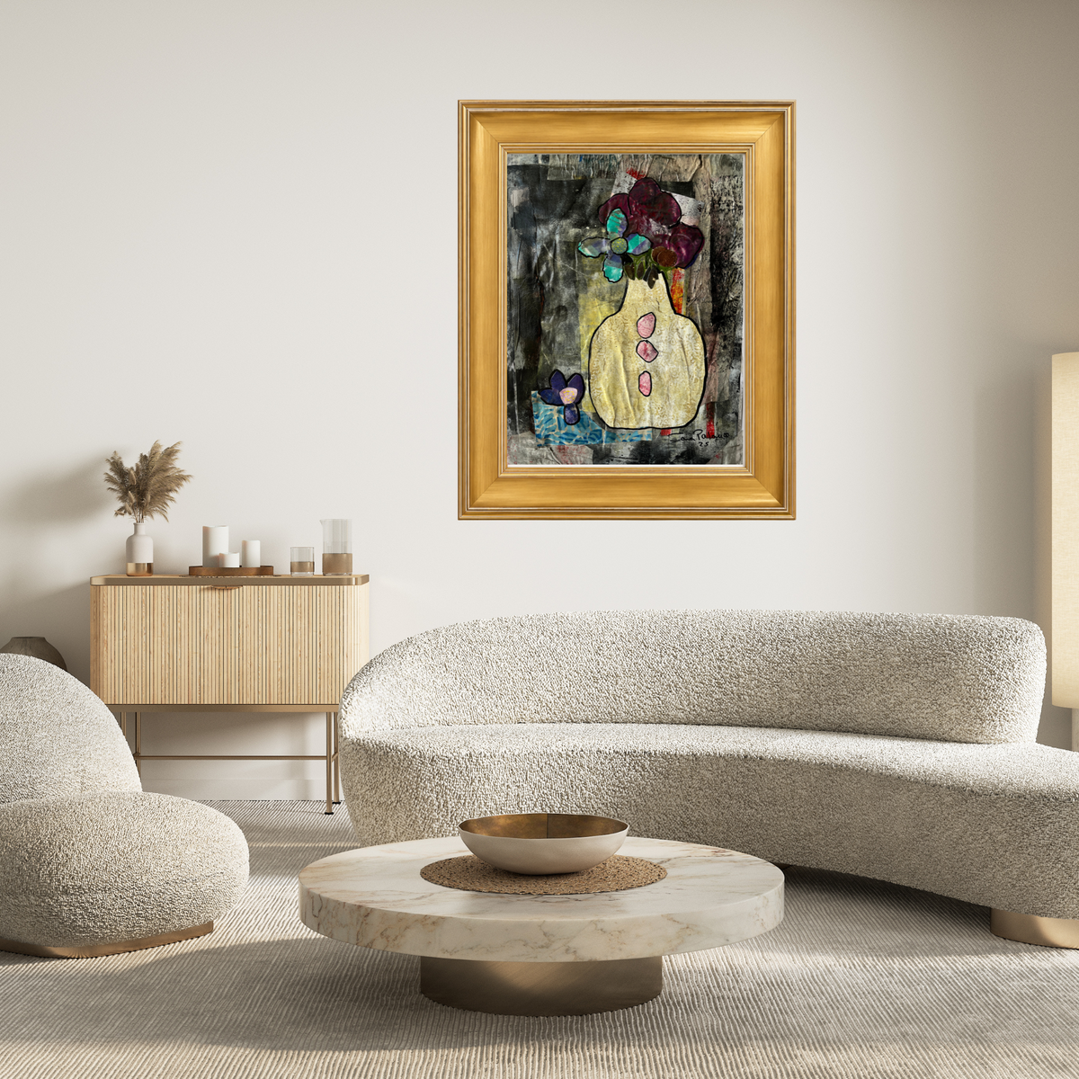 A framed abstract painting featuring a yellow vase with colorful flowers, hung on a light beige wall in a modern living room setting with a curved boucle sofa and a marble coffee table.