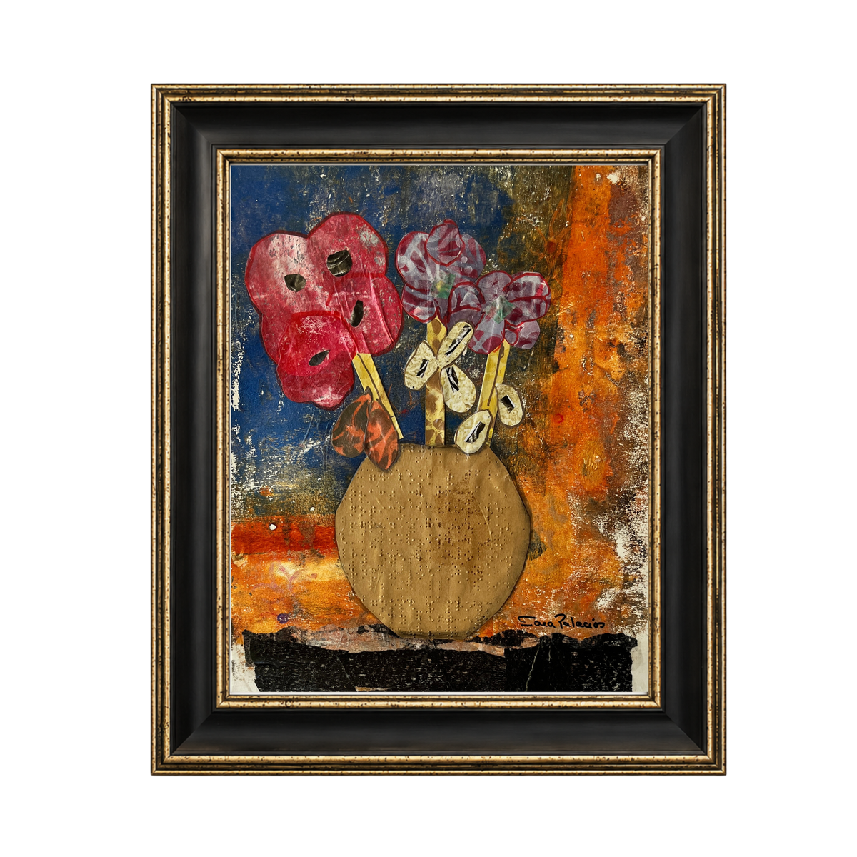 A framed abstract still life painting featuring two red theatrical masks and purple flowers in a round gold-toned vase, set against a textured blue, orange, and brown background. The artwork is housed in a black frame with a gold inner border, shown on a plain white background.