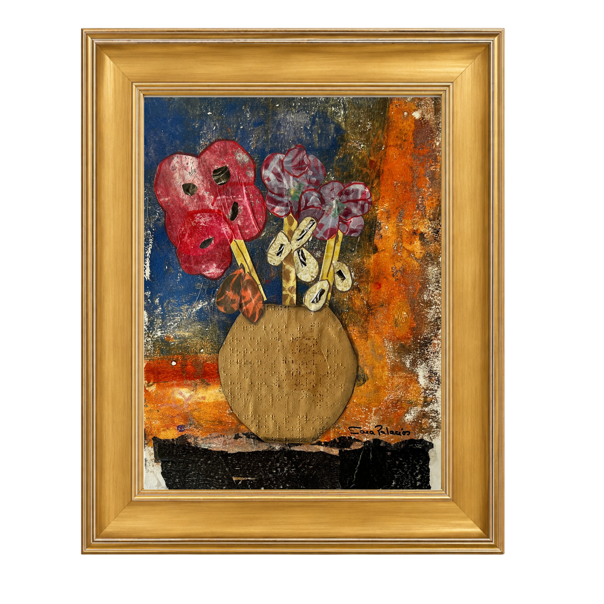 A framed abstract still life painting featuring two red theatrical masks and purple flowers in a round gold-toned vase, set against a textured blue, orange, and brown background. The artwork is housed in a gold frame, shown on a plain white background.