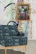an eclectic room, blue chair, sunday afternoon A3 framed in gold, artsy wallpaper.