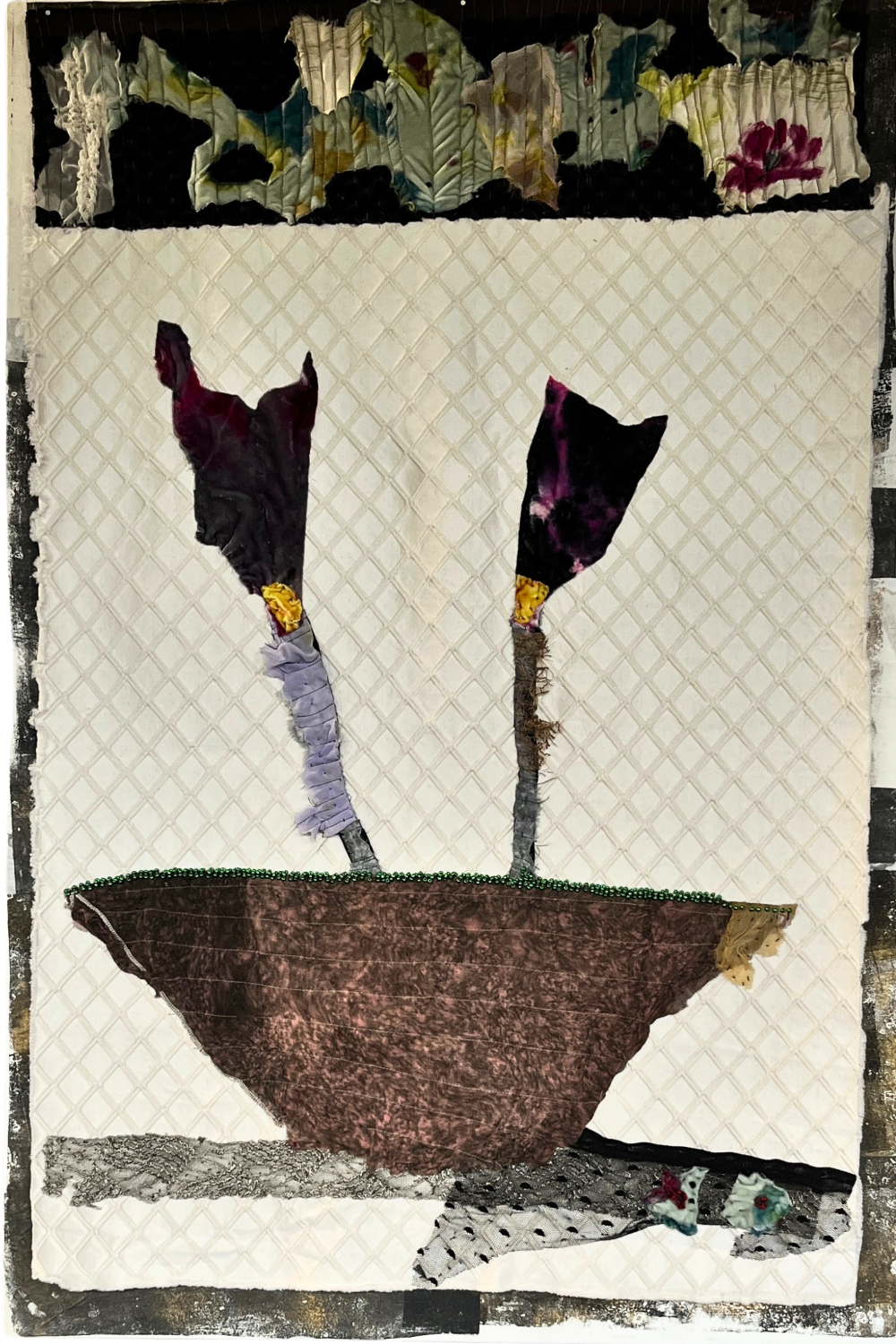 Textile art piece with abstract design featuring a bowl and flowers on a textured background.