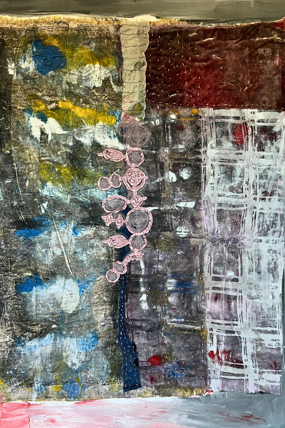 Original textile-on-paper abstract artwork featuring stitched pink textile elements, layered acrylic paint, collage, blue accents, and textured gray and burgundy surfaces.
