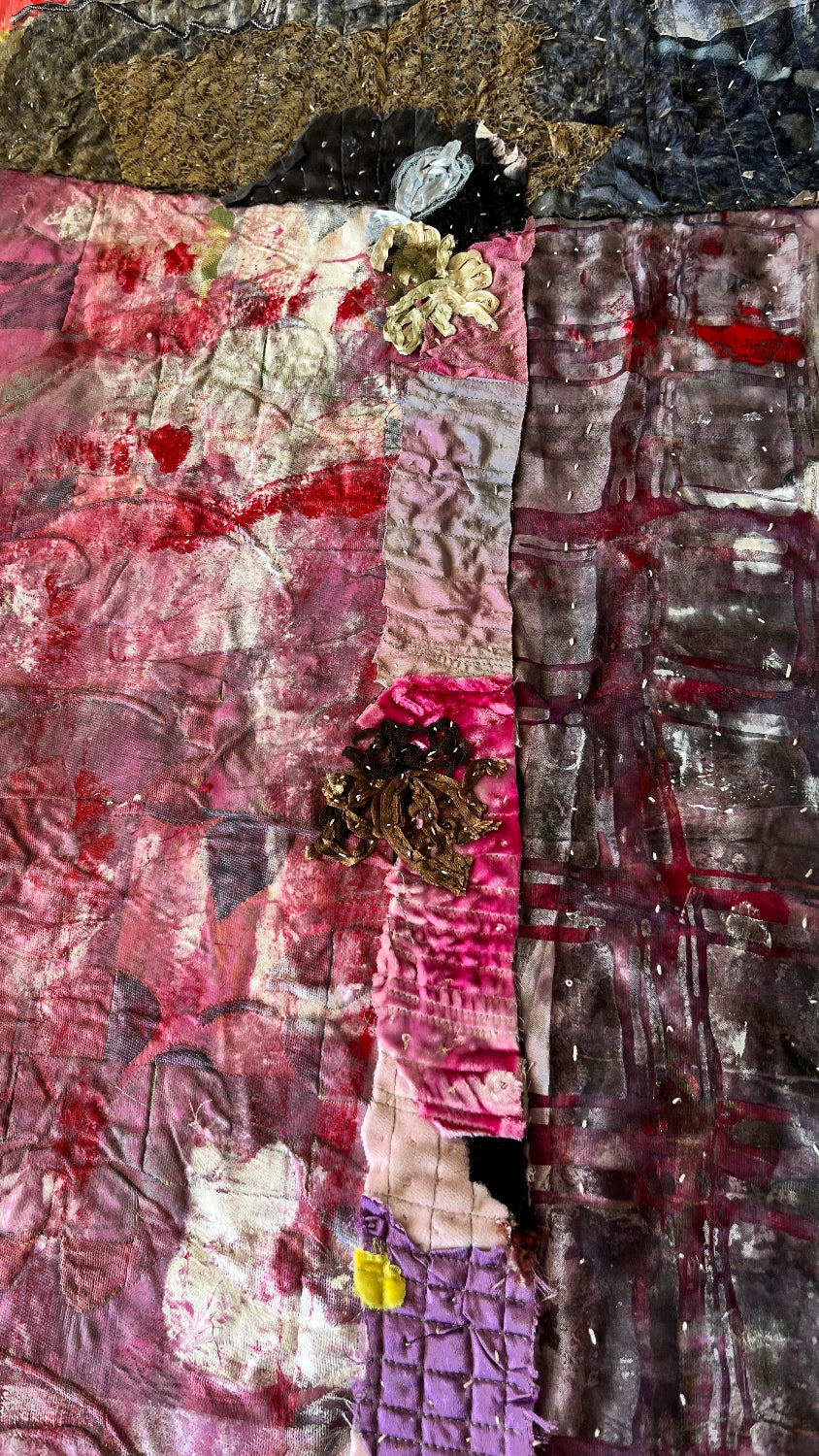 Detail of an original textile-on-paper abstract artwork with crimson, charcoal, plum, gray, lace details, stitched textiles, and layered mixed-media textures.
