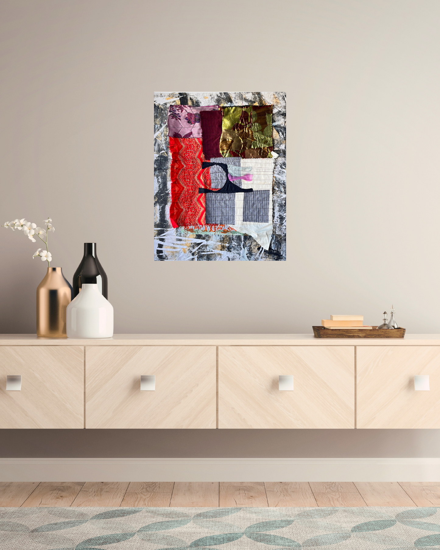 Abstract art piece on a wall above a wooden cabinet with decorative items.