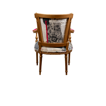 Verite Chair by Sara Palacios – a hand-painted, gold-framed accent chair upholstered with a bold patchwork textile featuring abstract black patterns, warm ochre tones, and striking fuchsia accents.