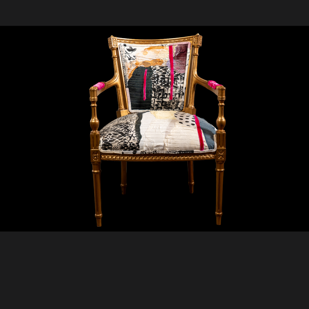 Verite Chair by Sara Palacios – a hand-painted, gold-framed accent chair upholstered with a bold patchwork textile featuring abstract black patterns, warm ochre tones, and striking fuchsia accents.