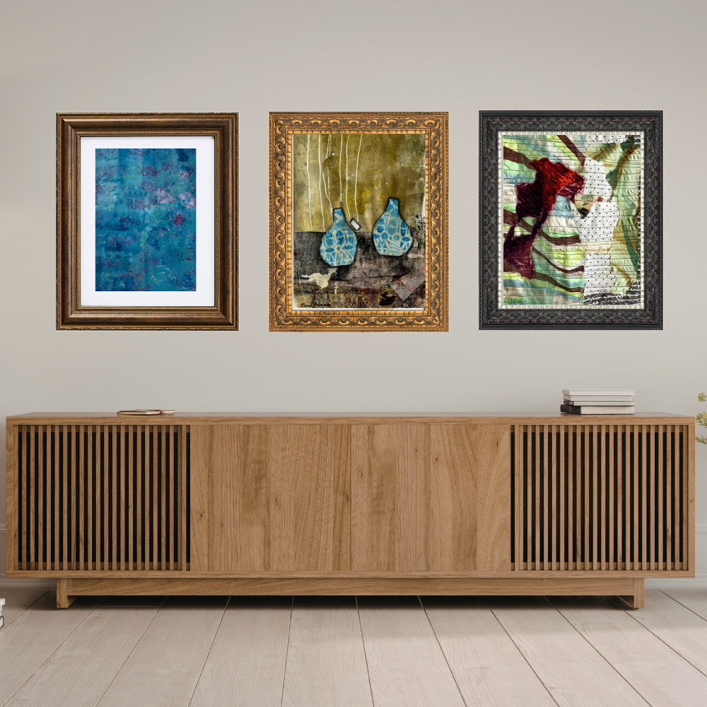 Three framed artworks above a wooden sideboard in a room.